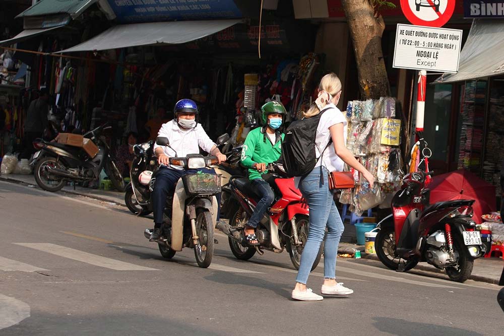 Crossing the street in Vietnam. Navigating the Currents: The Unique Flow of Vietnam's Streets